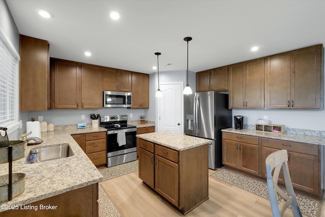 124 Shadow Rock Ct, Shepherdsville, KY 40165 - kitchen with stainless steel appliances, light wood finished floors, recessed lighting, a center island, and light stone counters