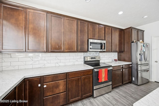 14433 Halden Ridge Way, Louisville, KY 40245 - kitchen with appliances with stainless steel finishes, light wood-type flooring, light countertops, backsplash, and recessed lighting