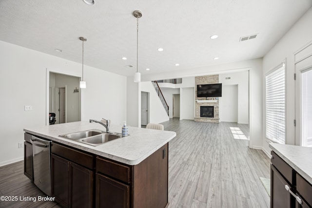 14433 Halden Ridge Way, Louisville, KY 40245 - kitchen featuring light countertops, a fireplace, dark brown cabinetry, dishwasher, and recessed lighting