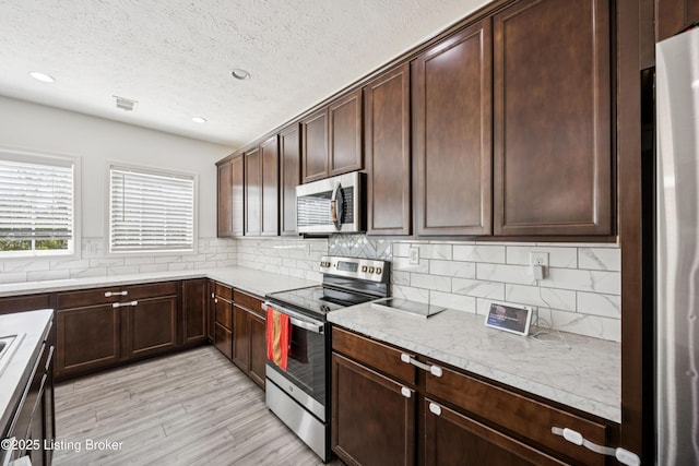 14433 Halden Ridge Way, Louisville, KY 40245 - kitchen with appliances with stainless steel finishes, backsplash, light wood-type flooring, dark brown cabinets, and recessed lighting