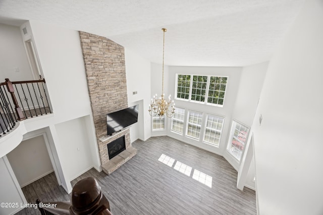 14433 Halden Ridge Way, Louisville, KY 40245 - unfurnished living room with a chandelier, wood finished floors, a fireplace, and high vaulted ceiling