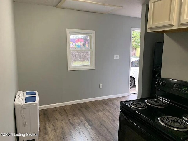 1214 Logan St, Louisville, KY 40204 - kitchen featuring black electric range oven and wood finished floors