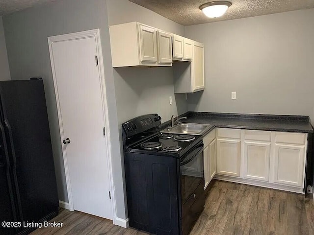 1214 Logan St, Louisville, KY 40204 - kitchen featuring black / electric stove, refrigerator with ice dispenser, wood finished floors, a textured ceiling, and dark countertops