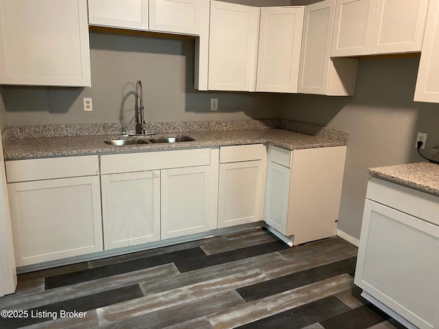 1214 Logan St, Louisville, KY 40204 - kitchen featuring white cabinetry and dark wood finished floors