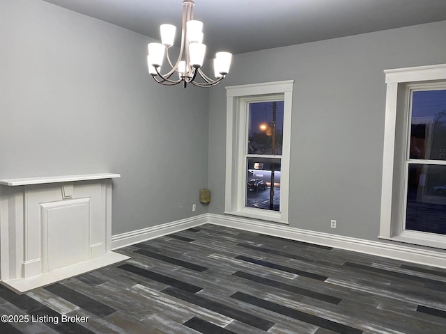 1214 Logan St, Louisville, KY 40204 - unfurnished dining area featuring wood finished floors and a chandelier