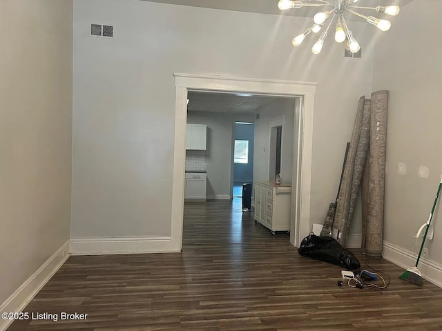 1214 Logan St, Louisville, KY 40204 - empty room featuring a chandelier and dark wood-type flooring