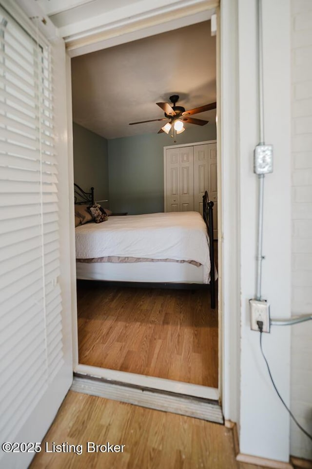 6812 Holly Lake Dr, Louisville, KY 40291 - bedroom with wood finished floors, a closet, and a ceiling fan