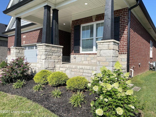 7508 Pavilion Park Rd, Louisville, KY 40214 - view of home's exterior with brick siding, a garage, stone siding, and a porch