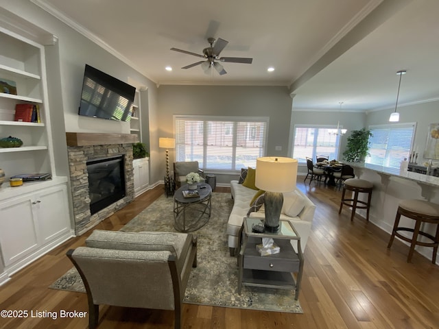 7508 Pavilion Park Rd, Louisville, KY 40214 - living room with a stone fireplace, ceiling fan, ornamental molding, wood finished floors, and recessed lighting