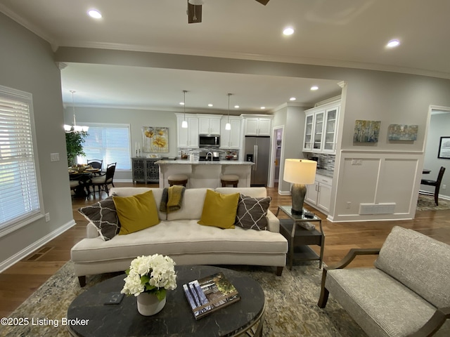 7508 Pavilion Park Rd, Louisville, KY 40214 - living room featuring crown molding, dark wood finished floors, recessed lighting, and a chandelier