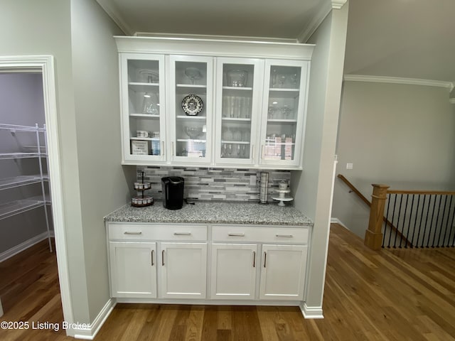 7508 Pavilion Park Rd, Louisville, KY 40214 - bar area with crown molding, wood finished floors, decorative backsplash, and radiator