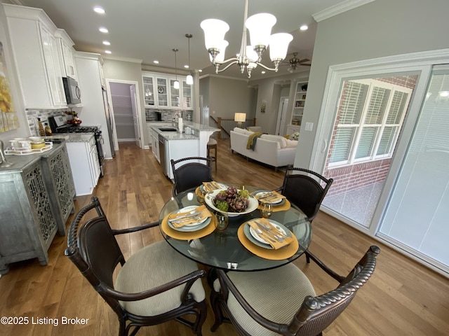7508 Pavilion Park Rd, Louisville, KY 40214 - dining room featuring crown molding, a chandelier, light wood-style flooring, and recessed lighting