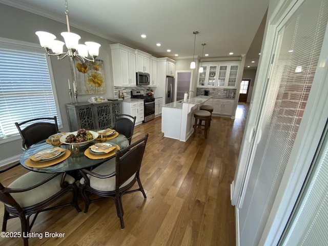 7508 Pavilion Park Rd, Louisville, KY 40214 - dining space featuring a chandelier, wood finished floors, crown molding, and recessed lighting