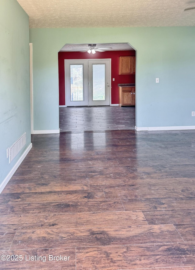 599 Ritchie Dr, Brandenburg, KY 40108 - spare room with arched walkways, a textured ceiling, wood finished floors, a ceiling fan, and french doors