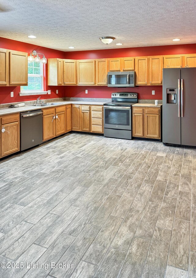 599 Ritchie Dr, Brandenburg, KY 40108 - kitchen featuring appliances with stainless steel finishes, light wood finished floors, a textured ceiling, light countertops, and recessed lighting