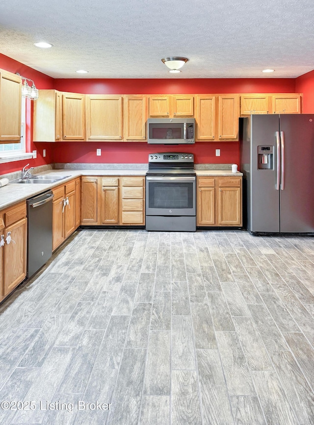 599 Ritchie Dr, Brandenburg, KY 40108 - kitchen with stainless steel appliances, wood tiled floors, a textured ceiling, light countertops, and recessed lighting