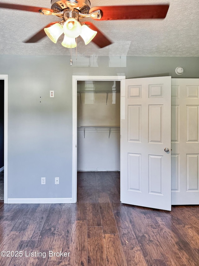 599 Ritchie Dr, Brandenburg, KY 40108 - unfurnished bedroom featuring a closet, dark wood-type flooring, a textured ceiling, and ceiling fan