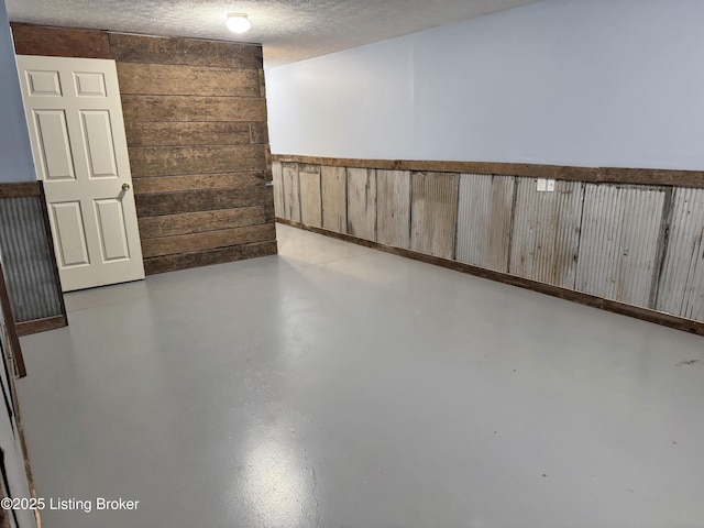 599 Ritchie Dr, Brandenburg, KY 40108 - below grade area featuring wood walls and a textured ceiling