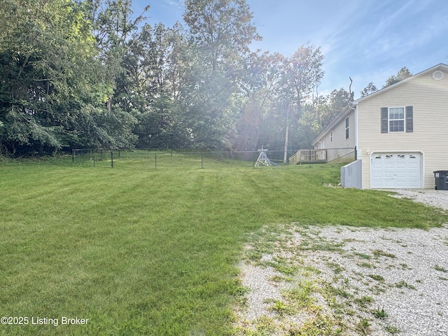 599 Ritchie Dr, Brandenburg, KY 40108 - view of yard featuring an attached garage and driveway