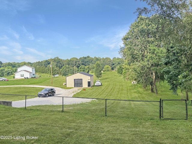 599 Ritchie Dr, Brandenburg, KY 40108 - view of yard featuring a detached garage, an outbuilding, dirt driveway, and a pole building