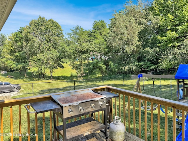 599 Ritchie Dr, Brandenburg, KY 40108 - wooden deck with a fenced backyard, view of wooded area, and a grill
