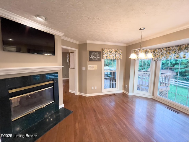 4212 Marseille Dr, Louisville, KY 40272 - unfurnished living room featuring wood finished floors, a glass covered fireplace, a textured ceiling, a chandelier, and ornamental molding