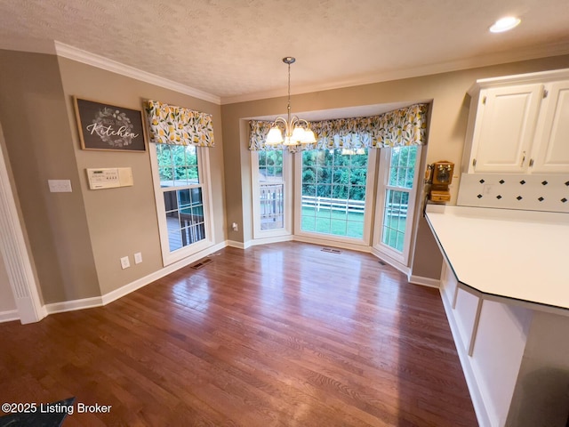 4212 Marseille Dr, Louisville, KY 40272 - unfurnished dining area with dark wood-style flooring, a chandelier, ornamental molding, a textured ceiling, and recessed lighting