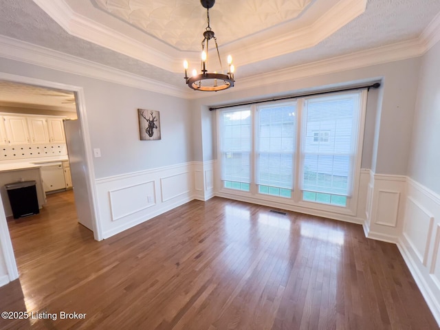 4212 Marseille Dr, Louisville, KY 40272 - spare room featuring a chandelier, a tray ceiling, wood finished floors, a wainscoted wall, and a decorative wall
