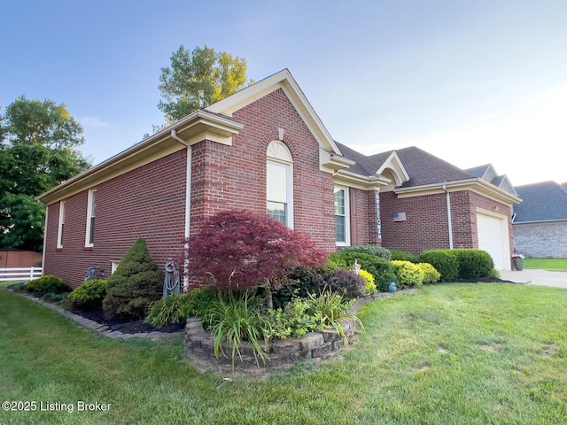 4212 Marseille Dr, Louisville, KY 40272 - view of property exterior featuring brick siding, an attached garage, a lawn, and driveway
