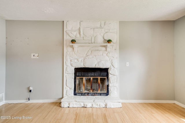 2700 Pioneer Ct, Radcliff, KY 40160 - detailed view of wood finished floors, a stone fireplace, and a textured ceiling