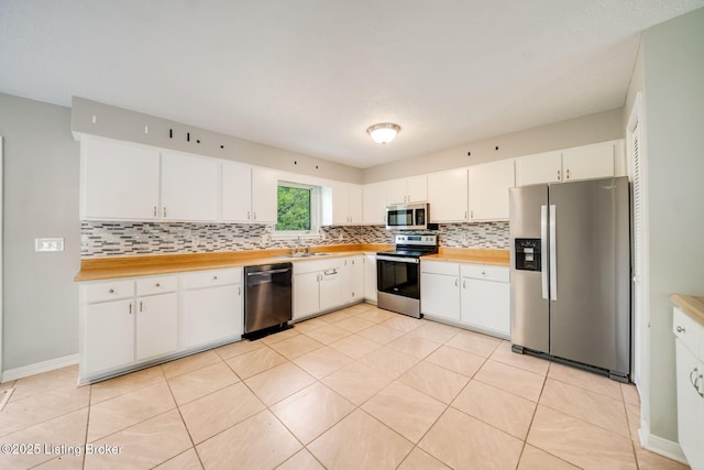 2700 Pioneer Ct, Radcliff, KY 40160 - kitchen featuring stainless steel appliances, tasteful backsplash, light countertops, and white cabinetry