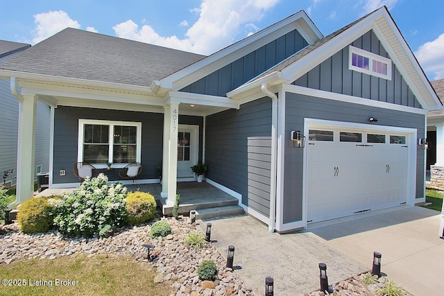 4017 Williams Crossing Way, Jeffersonville, IN 47130 - view of front of house with board and batten siding, a porch, an attached garage, concrete driveway, and roof with shingles