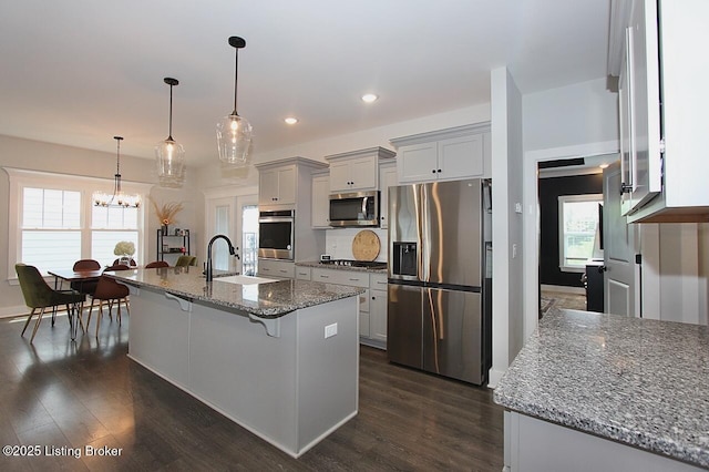 4017 Williams Crossing Way, Jeffersonville, IN 47130 - kitchen featuring stainless steel appliances, a breakfast bar, dark wood-type flooring, a chandelier, and recessed lighting
