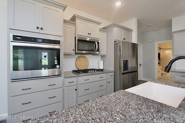 4017 Williams Crossing Way, Jeffersonville, IN 47130 - kitchen with stainless steel appliances, backsplash, dark stone counters, and recessed lighting