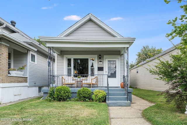 1021 Mulberry St, Louisville, KY 40217 - shotgun-style home with a porch and a front lawn