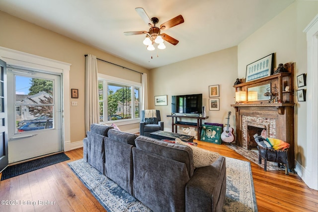 1021 Mulberry St, Louisville, KY 40217 - living room with a ceiling fan, plenty of natural light, hardwood / wood-style floors, and a brick fireplace