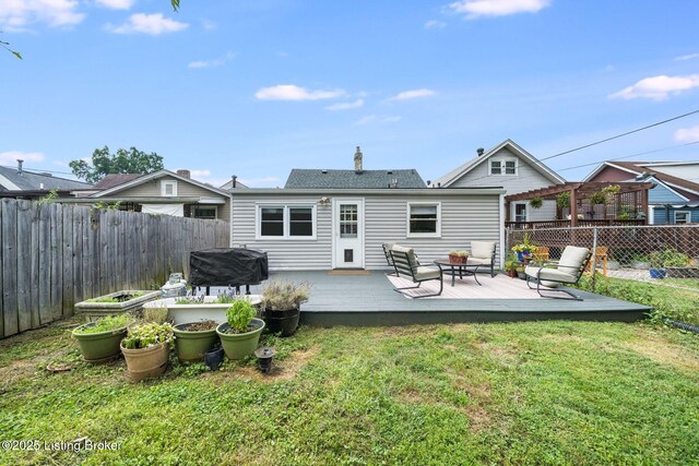 1021 Mulberry St, Louisville, KY 40217 - rear view of property featuring a fenced backyard, a deck, and an outdoor hangout area