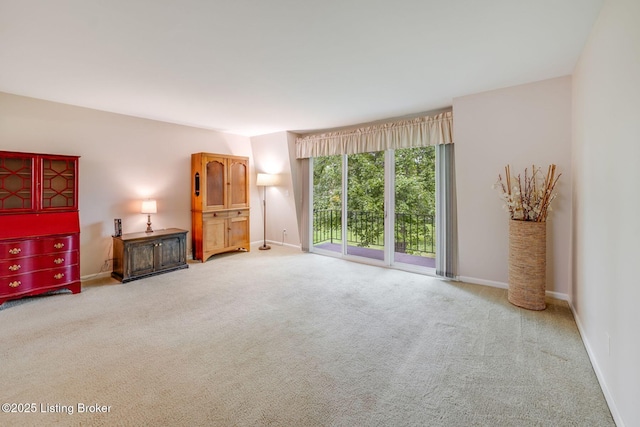 521 Zorn Ave Apt G8, Louisville, KY 40206 - unfurnished living room featuring carpet flooring and baseboards