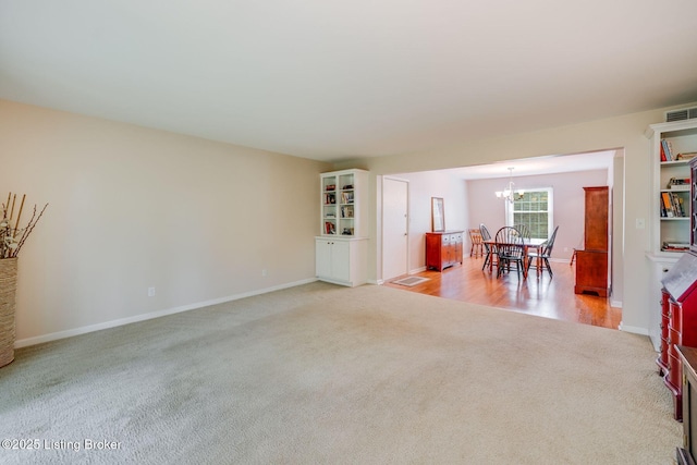 521 Zorn Ave Apt G8, Louisville, KY 40206 - dining room featuring light colored carpet and a chandelier