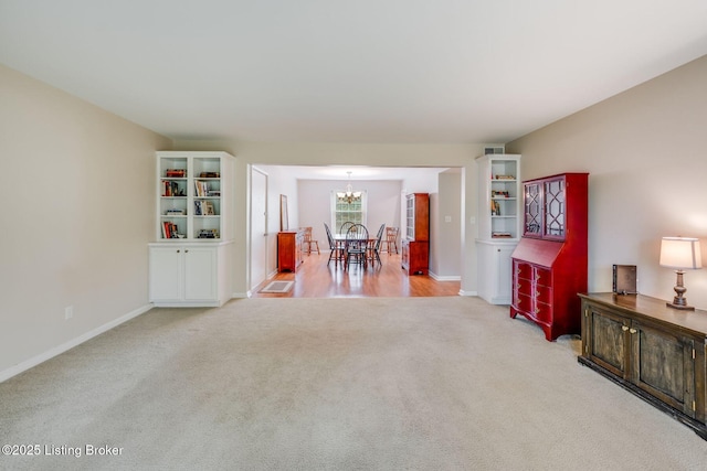 521 Zorn Ave Apt G8, Louisville, KY 40206 - living area featuring light colored carpet and a chandelier