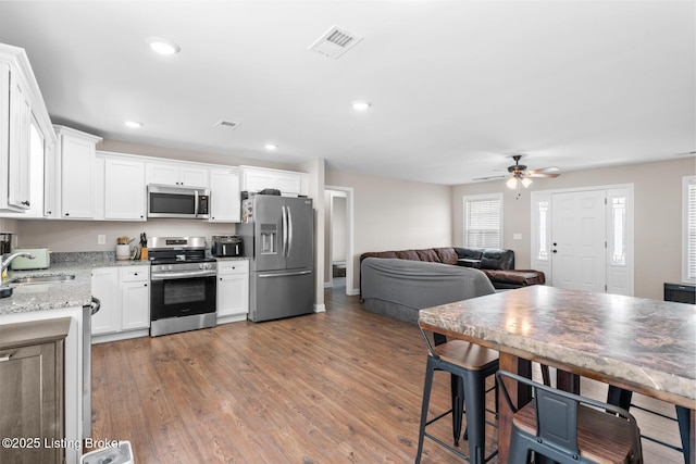 112 Shallow Springs Ct, Bardstown, KY 40004 - kitchen with appliances with stainless steel finishes, ceiling fan, white cabinets, light stone counters, and recessed lighting
