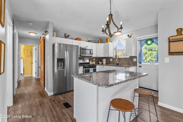 166 Glenview Rd, Shepherdsville, KY 40229 - kitchen featuring appliances with stainless steel finishes, white cabinets, dark wood-style floors, decorative backsplash, and dark stone counters