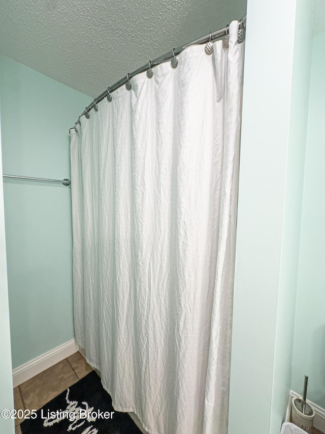 173 Megan Way, Falls Of Rough, KY 40119 - full bath with a textured ceiling, tile patterned flooring, and a shower with shower curtain