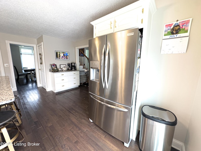 173 Megan Way, Falls Of Rough, KY 40119 - kitchen with stainless steel fridge with ice dispenser, dark wood-type flooring, a textured ceiling, white cabinets, and light stone counters