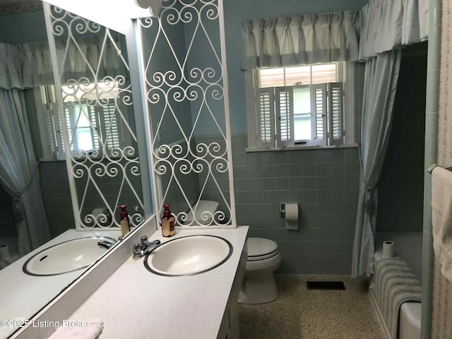 1600 Normandy Rd, Taylorsville, KY 40071 - full bathroom with radiator, shower / bath combo with shower curtain, speckled floor, vanity, and tile walls