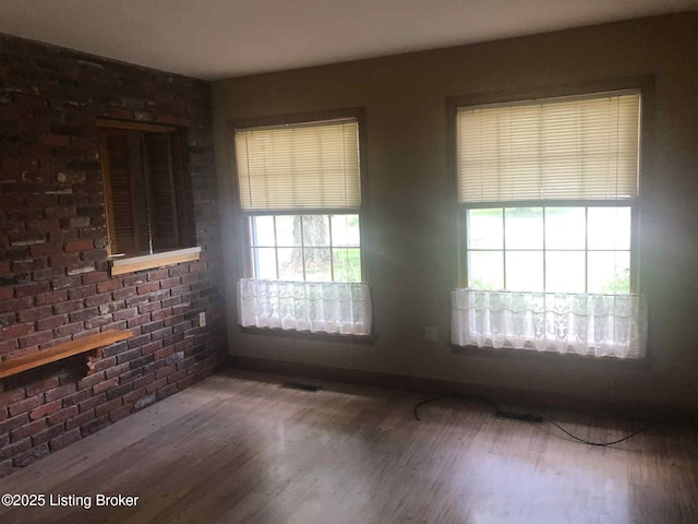 1600 Normandy Rd, Taylorsville, KY 40071 - unfurnished room with healthy amount of natural light, wood finished floors, and brick wall
