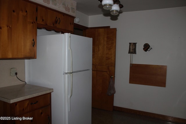 1600 Normandy Rd, Taylorsville, KY 40071 - kitchen featuring freestanding refrigerator, brown cabinetry, and light countertops