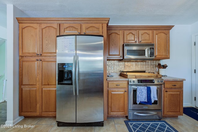 9602 Willowwood Way, Louisville, KY 40299 - kitchen with appliances with stainless steel finishes, backsplash, light countertops, and brown cabinets