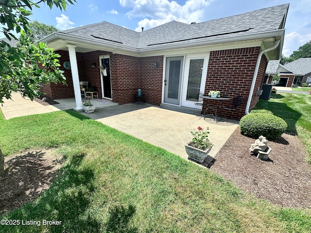 7520 Autumn Pointe Dr, Louisville, KY 40214 - back of house featuring brick siding, a patio, a lawn, and a shingled roof