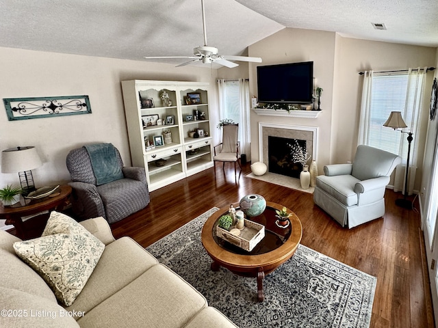 7520 Autumn Pointe Dr, Louisville, KY 40214 - living area with a textured ceiling, wood finished floors, lofted ceiling, ceiling fan, and a fireplace with flush hearth
